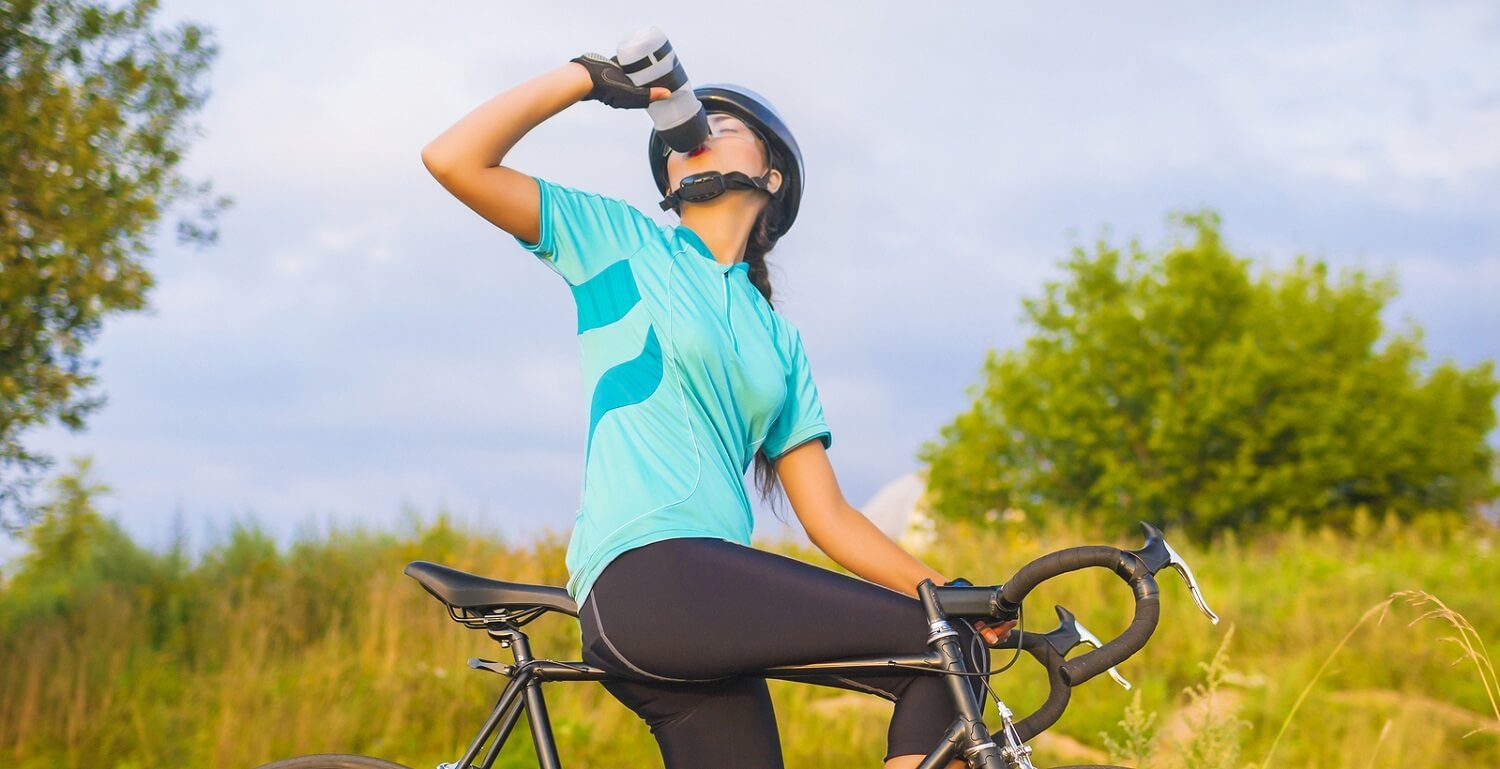 Portrait of young female cyclist athlete having a break.horizontal image